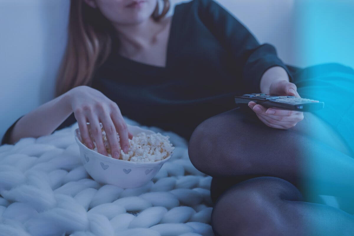 Woman Eating Popcorn And Watching Tv