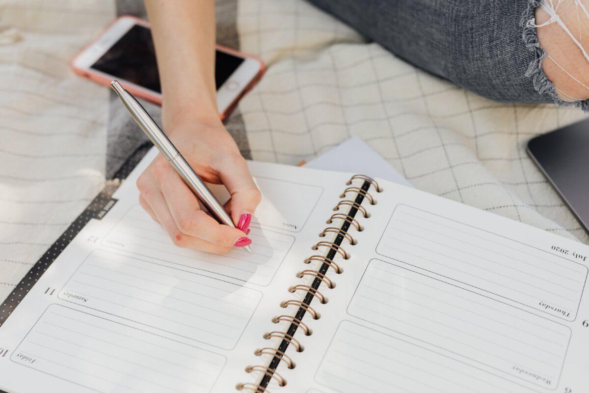 Woman Writing In Calendar Or Agenda