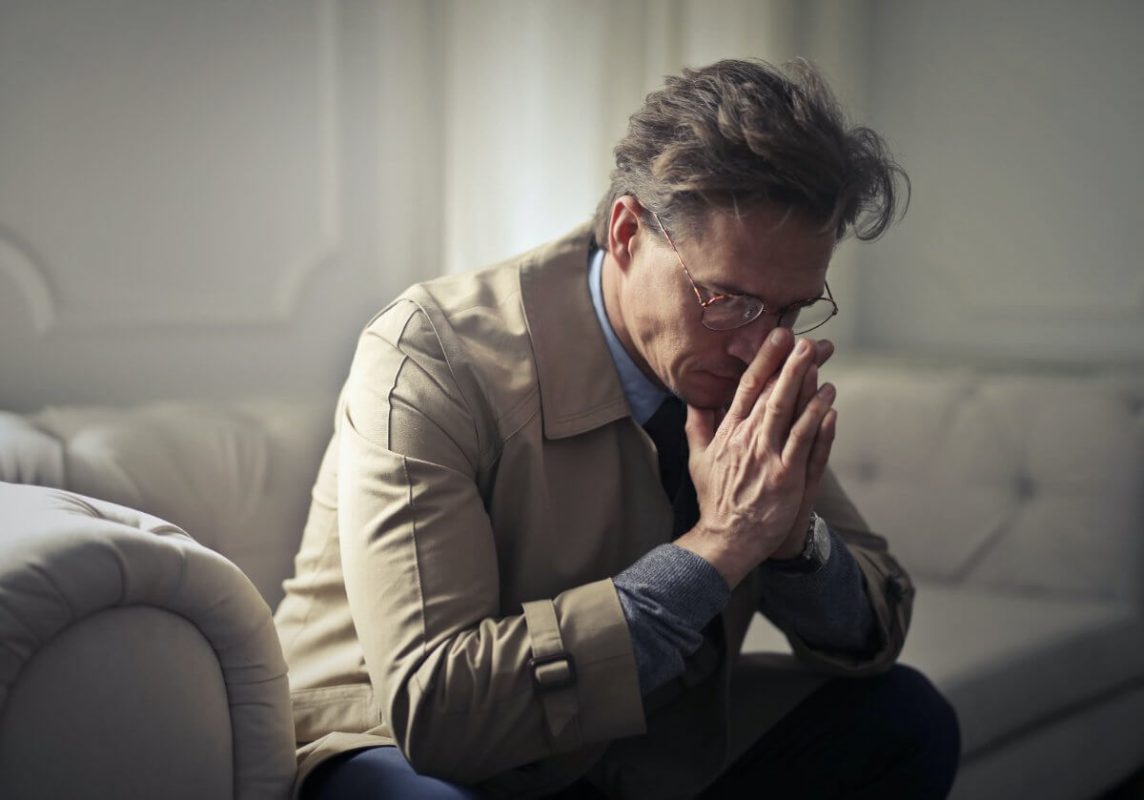 Man Sitting On Couch