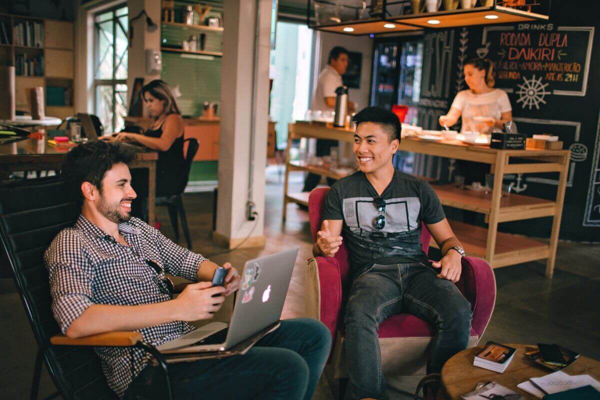 Two Men Talking To Each In A Coffee Shop