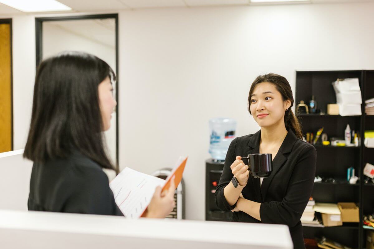 Woman Listening To Her Coworker Talking