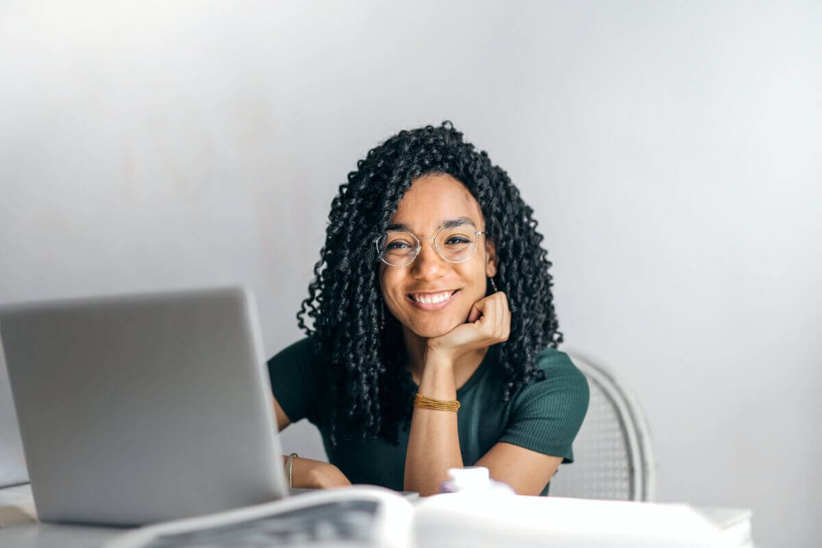 Woman Smiling Behind Computer