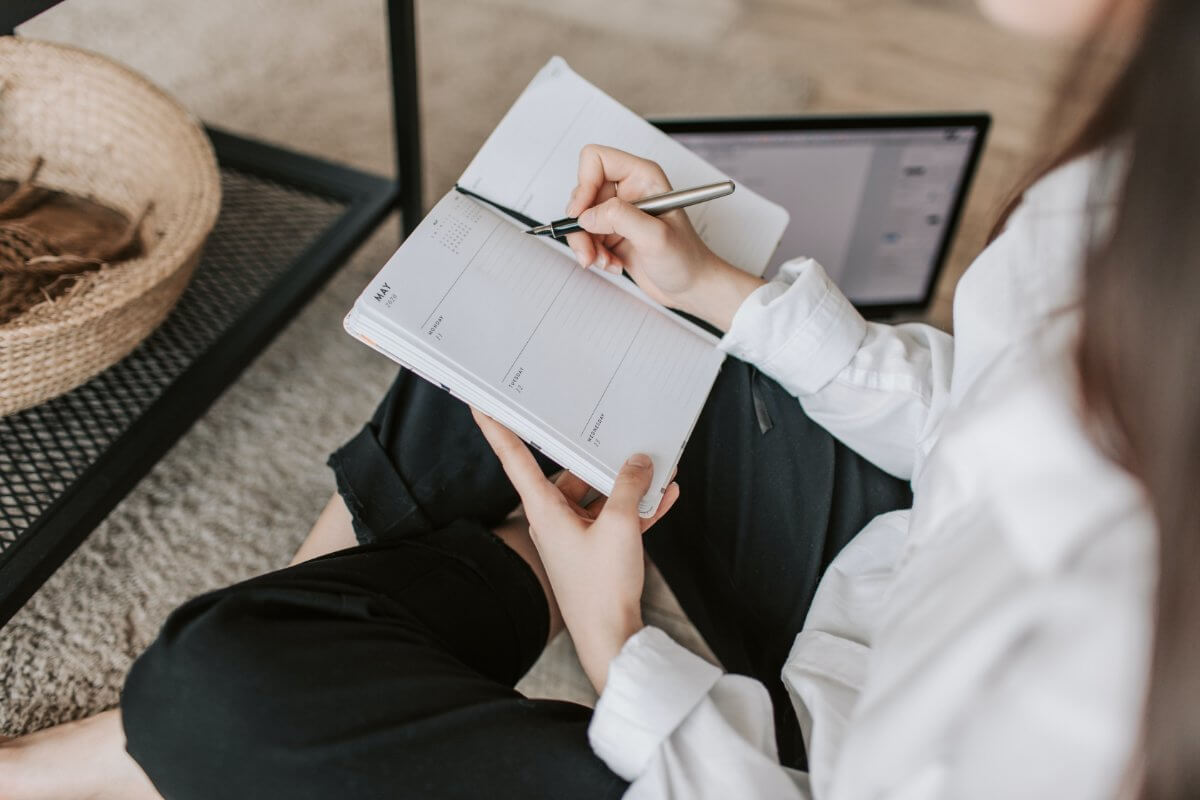 Woman Writing Into Her Schedule