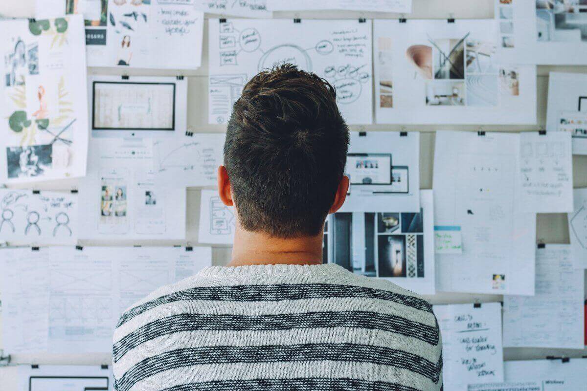 Man Looking At A Wall Full Of Notes