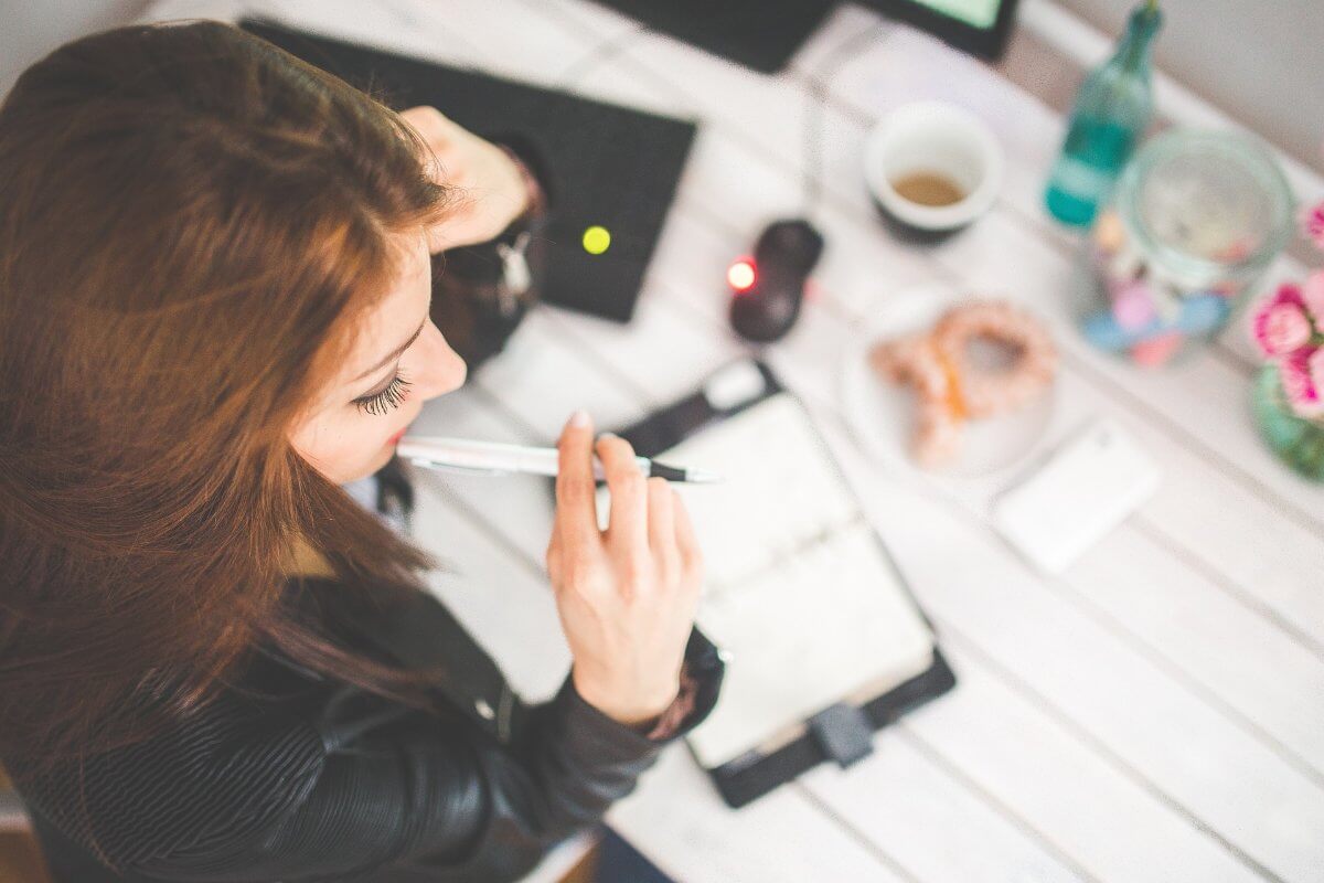 Woman Writing In Her Agenda